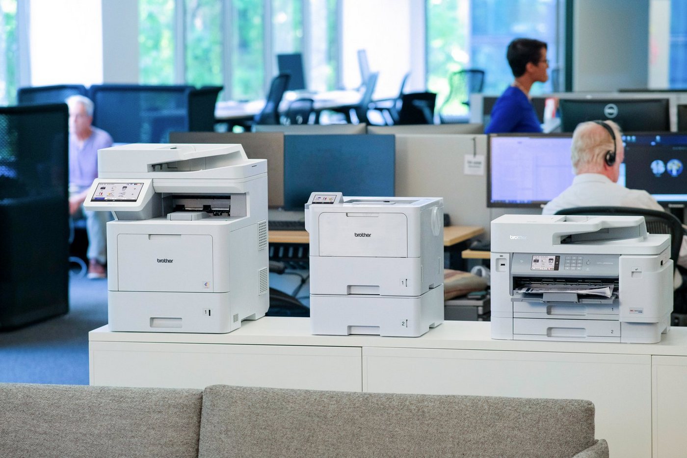 Brother business printers and all-in-ones on a counter in an open office